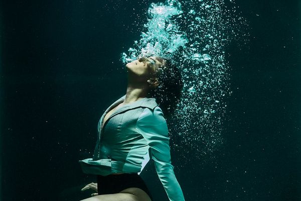 Person in activewear performing a fluid motion.